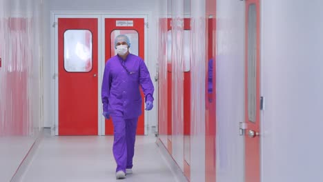 pharmaceutical factory worker. doctor in face mask moving in hospital corridor