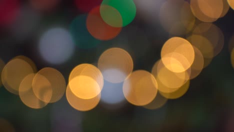 Shimmering abstract colored circles defocused christmas lights background. Blurred fairy lights. Out of focus holiday background christmas tree. Light bokeh from Xmas tree. Xmas and New Year theme. 4k video