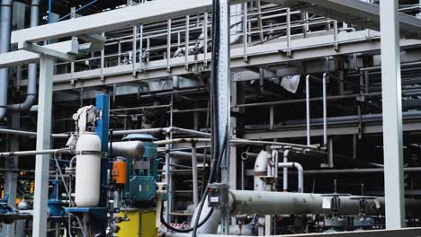 a welder repairs a pipeline at an oil refinery with bright flashes and sparks