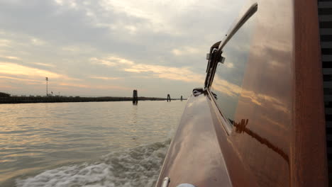 pov from water taxi boat to venice city - cloudy day