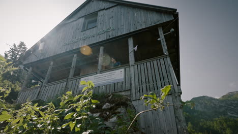 a low perspective of a vooden mountain cottage with a porch