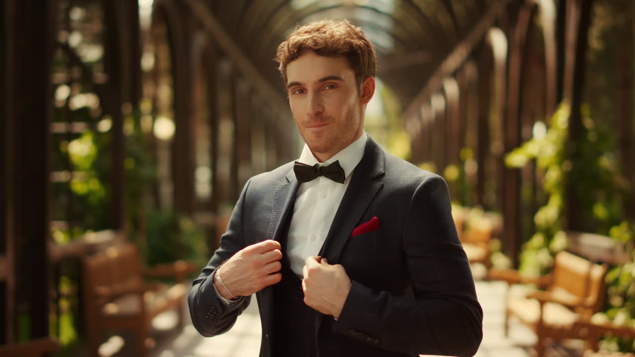 걱정하는 신랑은 아치  ⁇ 에서 불안하다. 매력적인 남자는 공원에서 더 나은 재 ⁇ 을 얻는다.