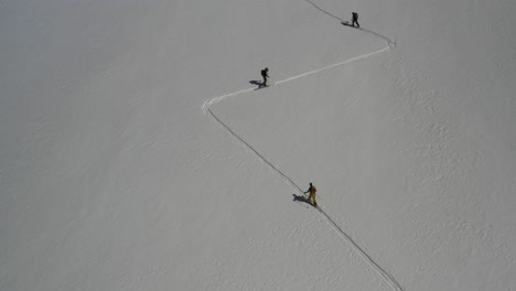 4k drone footage of backcountry skiers ascending glacier