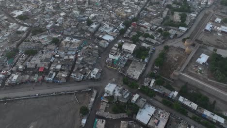 aerial drone zoom in shot over the city houses in umerkot city, tharparkar, pakistan on a cloudy day