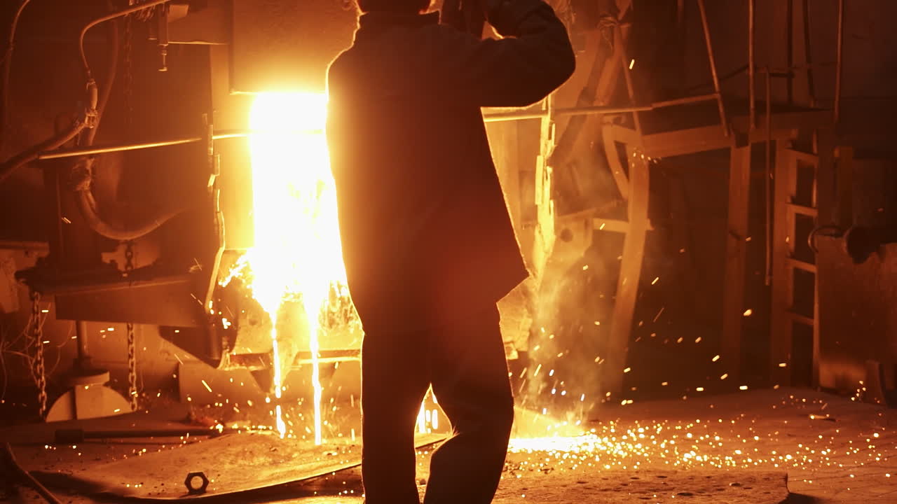 Steelworker pouring hot metal