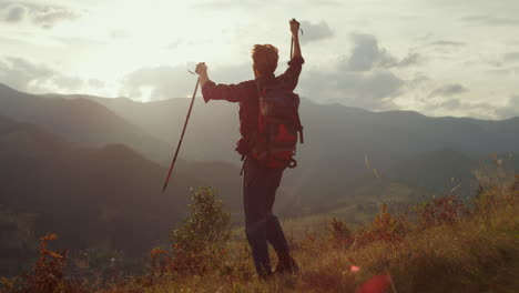 cheerful traveler celebrate freedom outdoors. young trekker hike mountains hill.