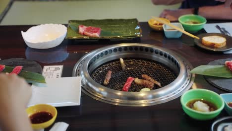 japanese wagyu being cooked at yakiniku restaurant, slow motion 4k shot