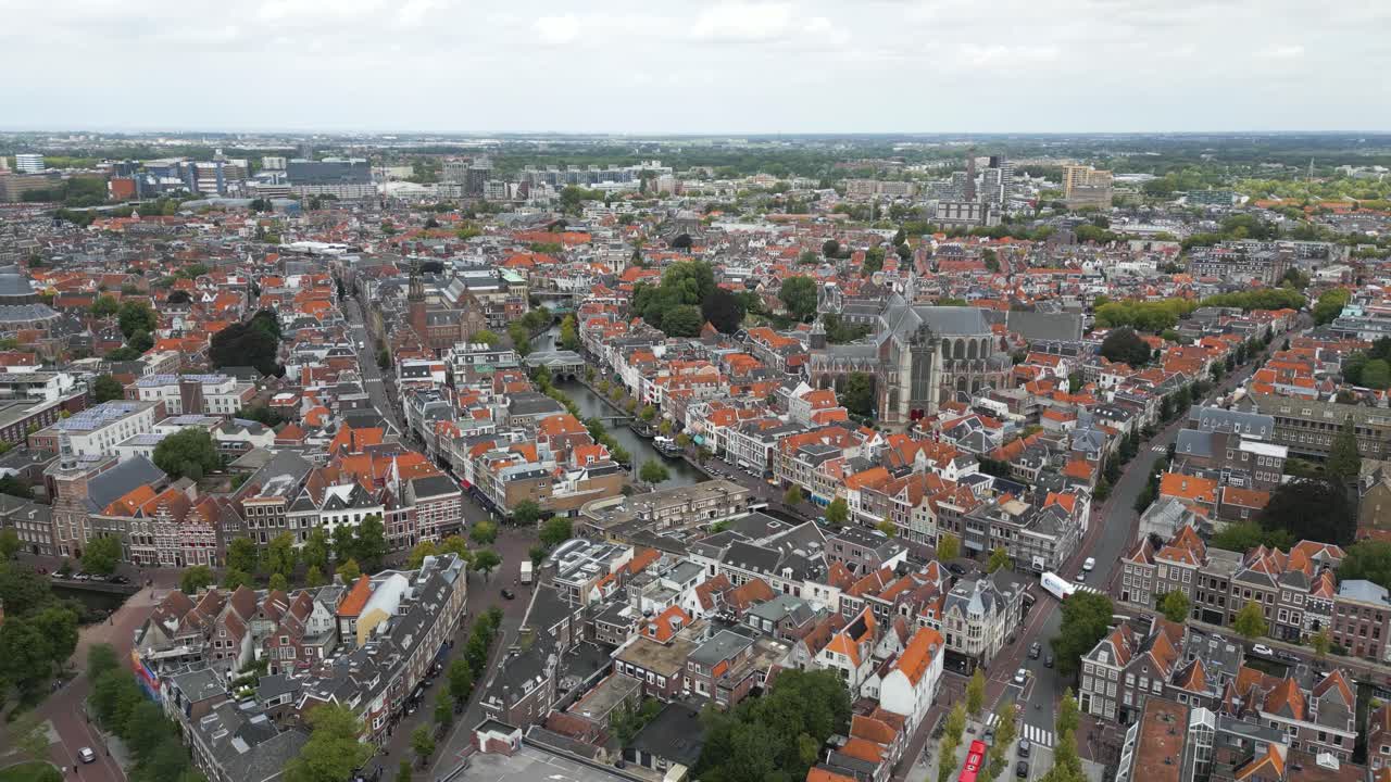 Drone footage of Leiden city center with traditional Dutch houses, canals, and historic churches