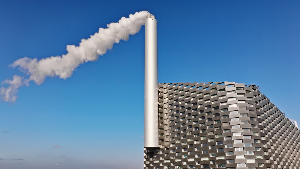 Aerial drone view of CopenHill artificial ski slope on the roof of an energy plant