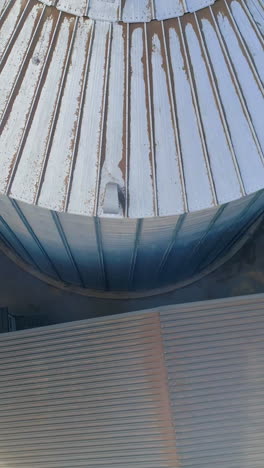 aerial top view of grain elevator. metal elevator in agriculture zone. vertical video