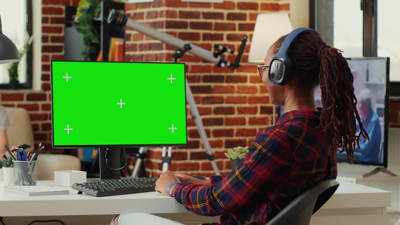 Office worker analyzing greenscreen template on monitor