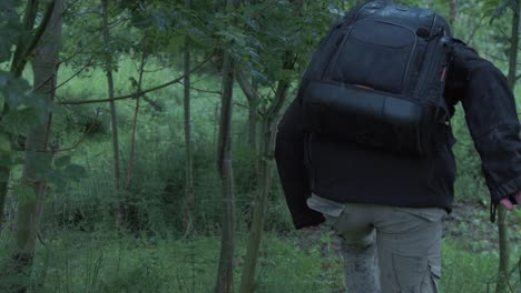 young refugee enters forest with belongings in backpack