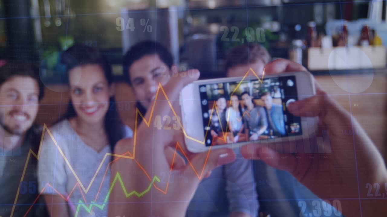 Trio leaning in to fit frame in cafe, hands raising phone, animated business charts occluding trio