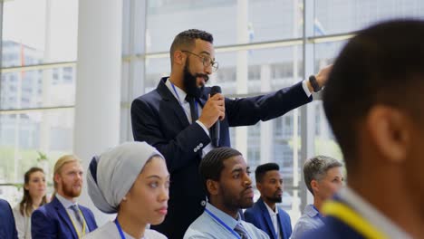 mixed-race businessman interacting with the speaker in the business seminar 4k