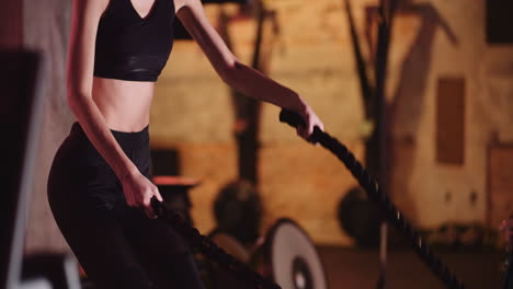 Attractive-Young-Fit-Female-Athlete-Exercising-With-Battle-Ropes-During-Cross-Training-1