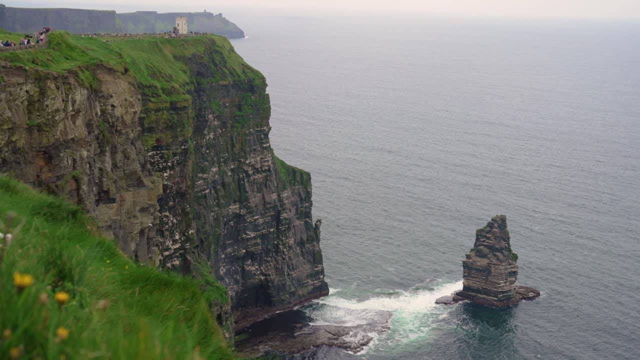 A breathtaking wide shot of the world-famous Cliffs of Moher in Ireland, featuring the iconic Branaunmore sea stack and O'Brien's Tower in the distance