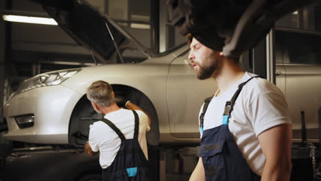 car repair technicians working on a vehicle