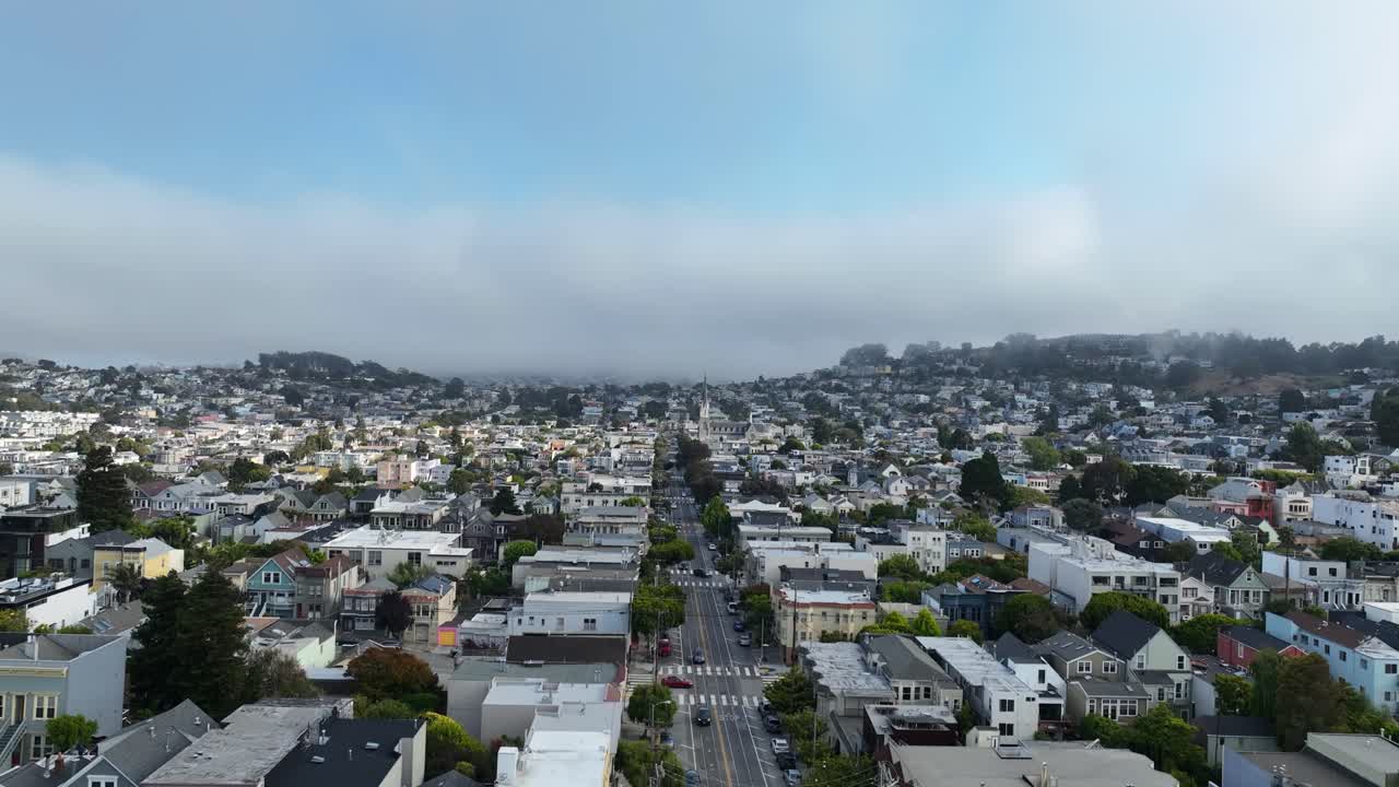 Aerial view flying over quiet neighborhood streets, foggy day in San Francisco