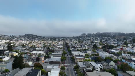 aerial view flying over quiet neighborhood streets, foggy day in san francisco
