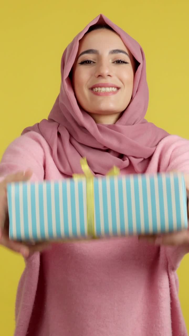 Woman in Hijab Smiling with Gift