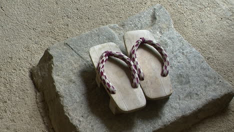 japanese geta sandals rest on a stone in a japanese house