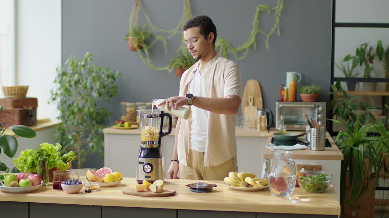 Man Adding Vegan Milk to Blender for Making Smoothie