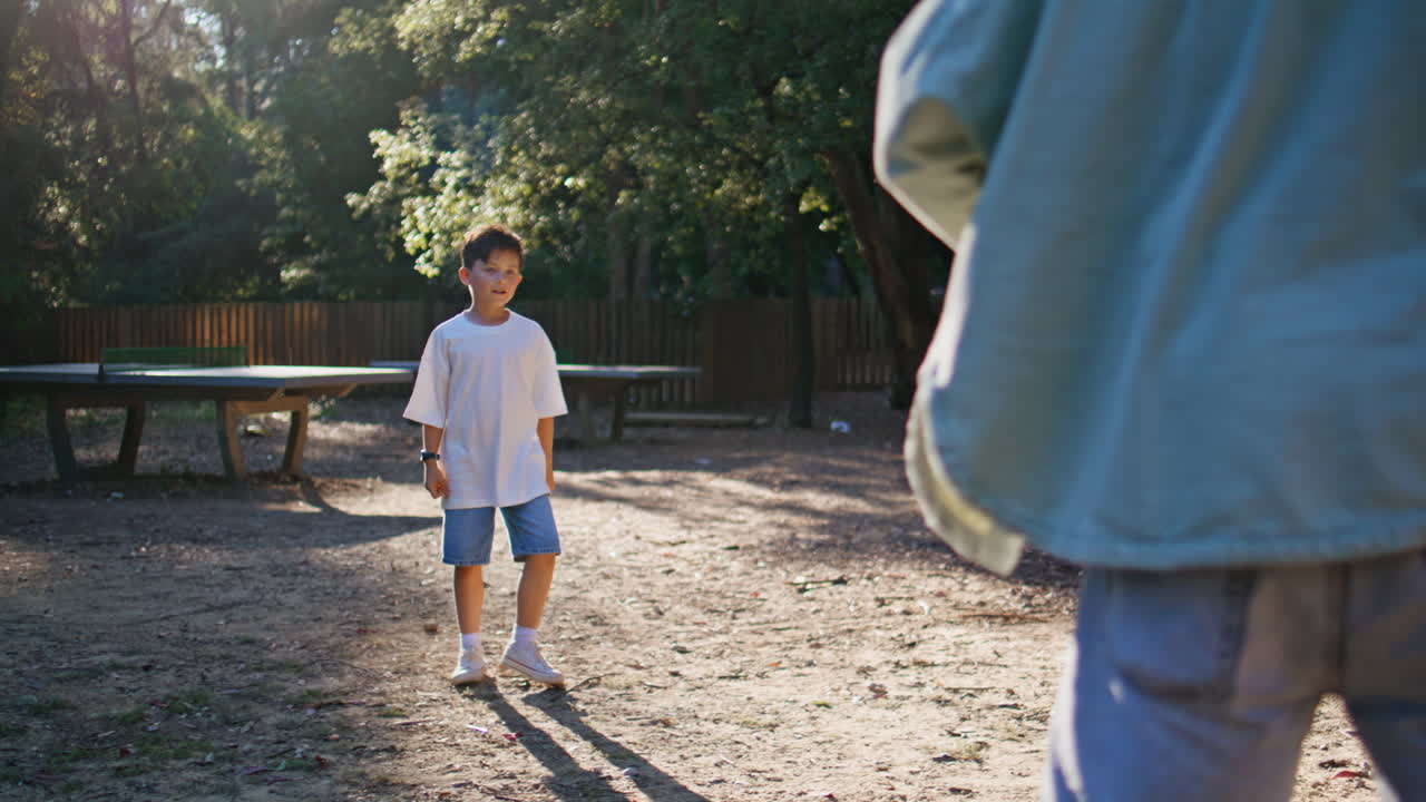 Father son playing frisbee summer park. Parent child spending weekend together