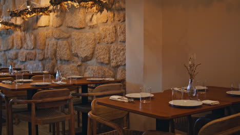 restaurant dining area with stone wall