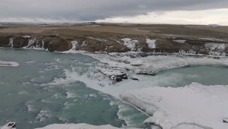 landscape of iceland, aerial view of urridafoss waterfall and cold glacial water of thjorsa river, drone shot