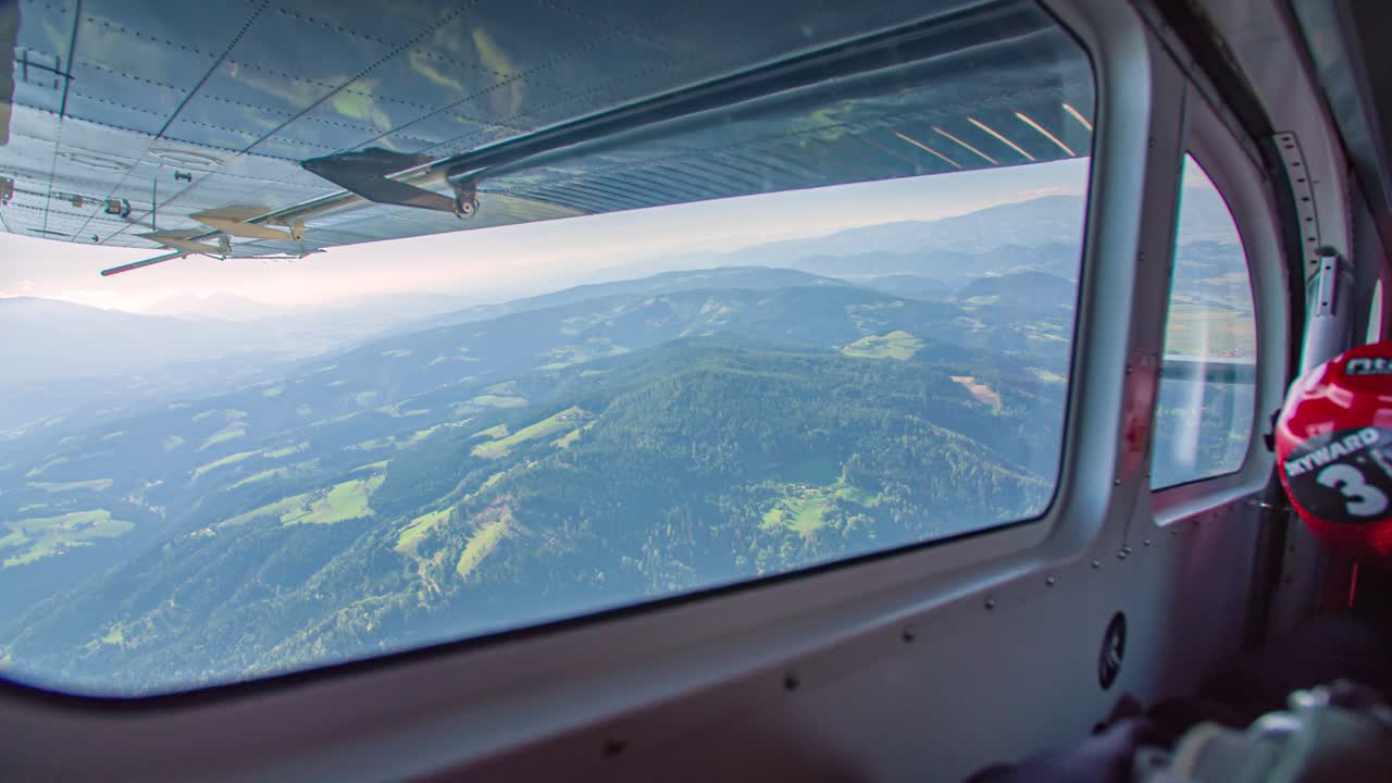 View from the side window of an airplane for the jump of parachutists. Parachute jump plane