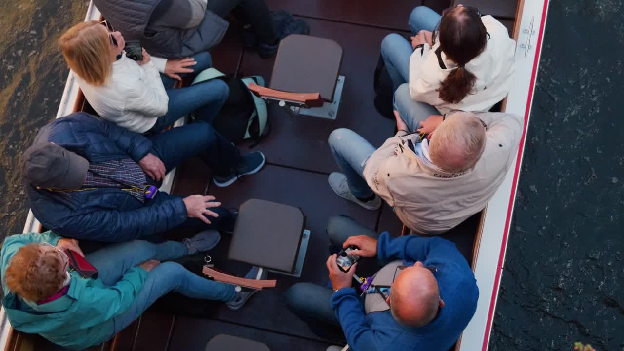 Tourists on a canal boat enjoying a scenic ride through historic Bruges, Belgium