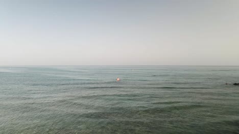 Aerial-dolly-with-people-kayaking-on-the-sea