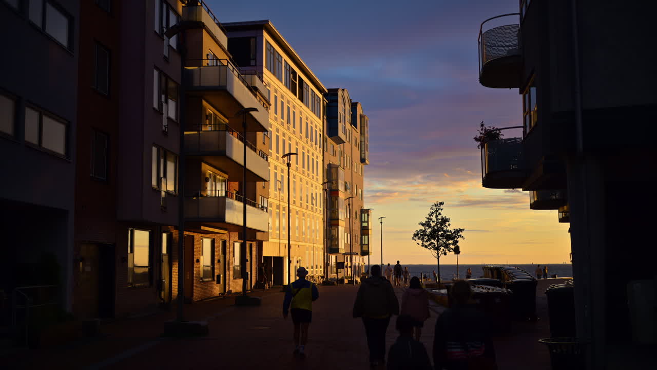 View of buildings on the shore of the sea in Malmo, Sweden at sunset