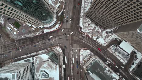 cinematic overhead vehicle traffic 4k time lapse winter drone shot canadian roadway trans highway one intersection portage avenue and main street capital city downtown winnipeg manitoba canada