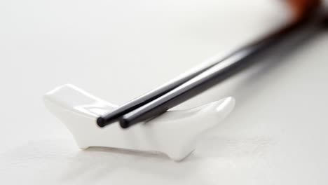 black chopsticks on a chopstick rest