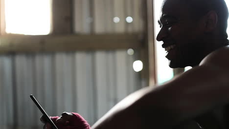 boxer using smartphone in the gym