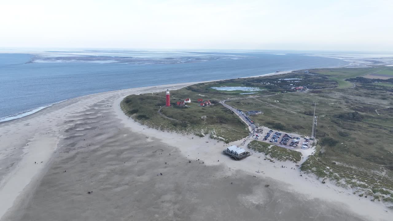 Lighthouse at the beach of Wadden island, Texel, The Netherlands. Aerial drone video.