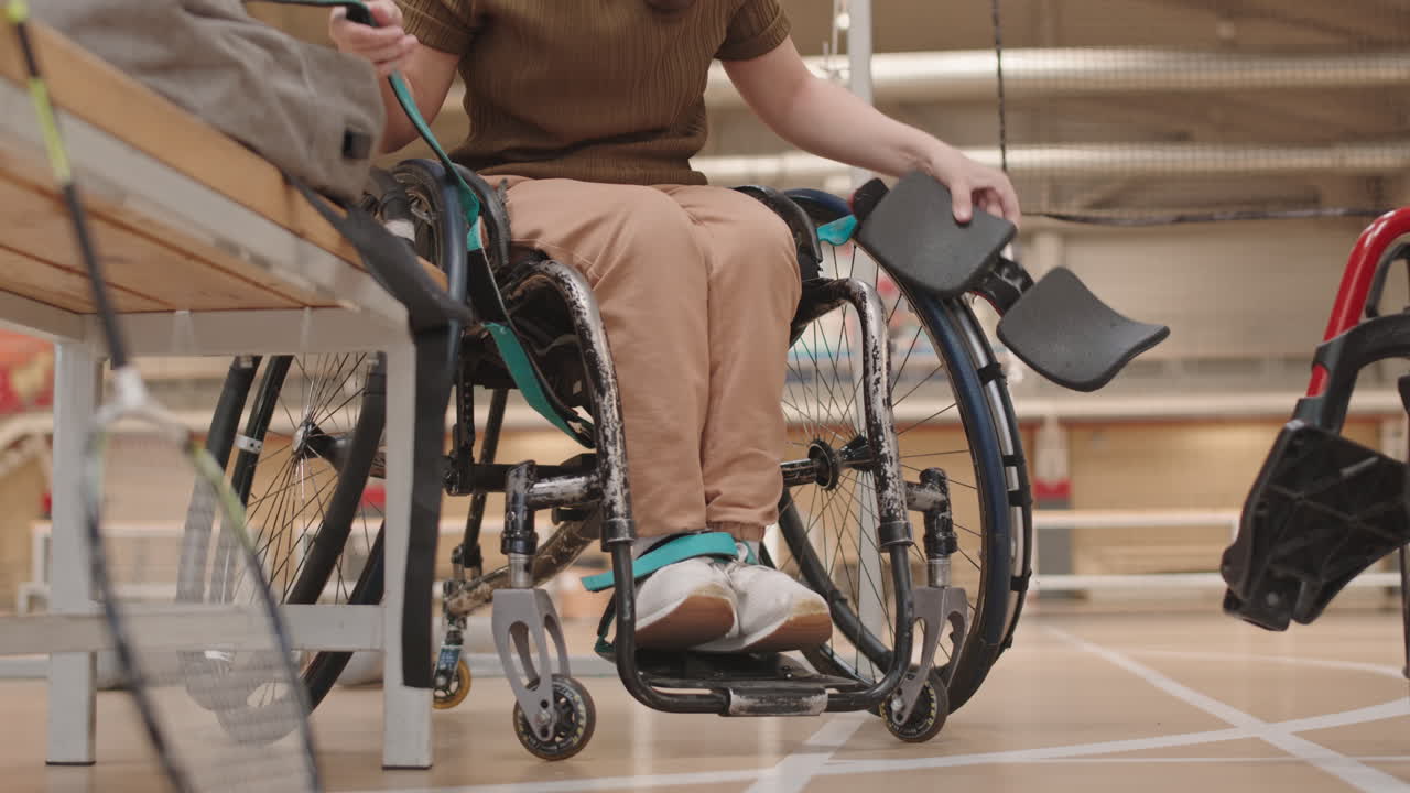 Athlete Securing Legs on Sports Wheelchair