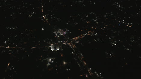 wide aerial hyperlapse of busy intersection in bo, sierra leone at night.