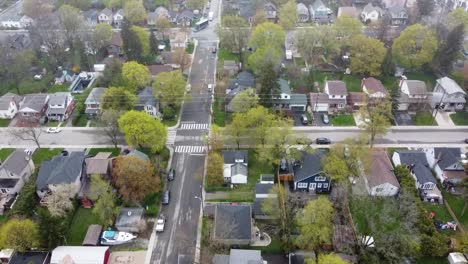 top-down aerial shot of a raining and foggy suburban neighborhood