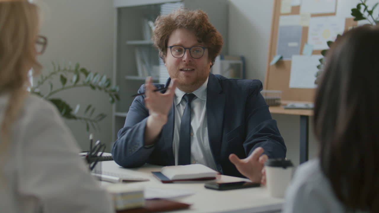 Businessman Leading Discussion during Office Meeting with Colleagues