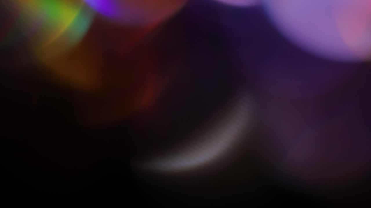 Multicolored light leaks 4k footage on black background, lens studio flare leak burst overlays