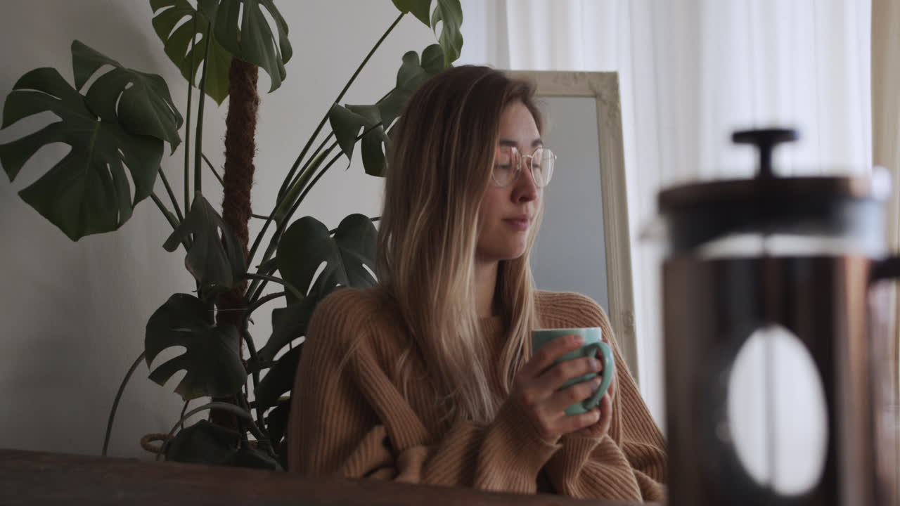 Girls has her morning coffee and looks out of window