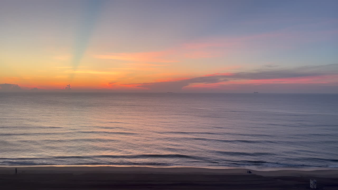 A serene sunrise unfolds over the Atlantic at Virginia Beach, featuring soft waves, pastel skies, and calm morning ambiance - perfect for nature, beachgoer, travel vlog, or relaxation video projects