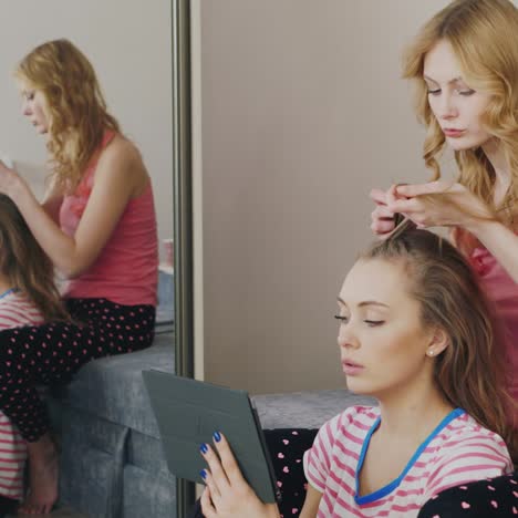 two young women paint the nails at home 4