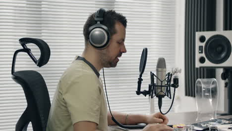 man recording podcast in home studio