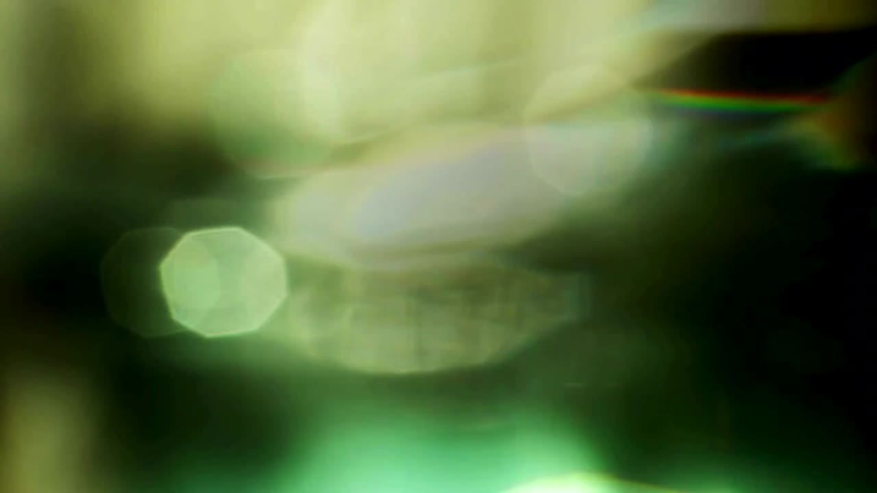 Abstract Green and Gold Bokeh Light Leaks Background