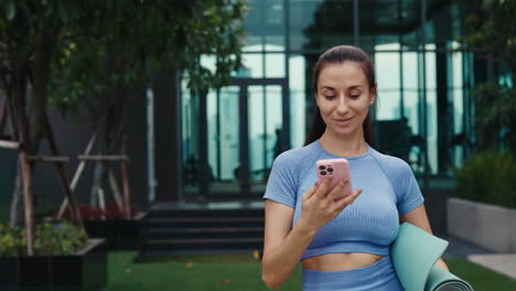 woman taking a selfie outdoors after yoga session
