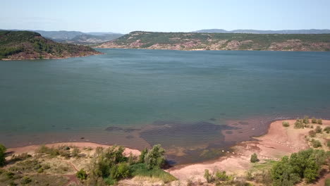 Drohnenaufnahme-Vom-Salagou-See-In-Frankreich,-Die-Nach-Oben-Und-Hinten-Fliegt-Und-Die-Gesamte-Landschaft-Des-Sees-Enthüllt