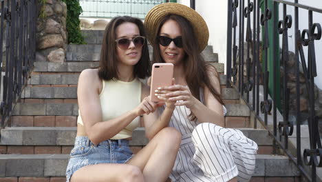 two women taking a selfie on stairs